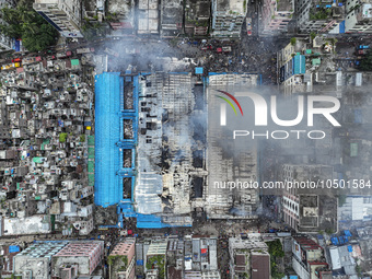 An aerial view shows smoke rises after a massive fire broke out, at the Mohammadpur Krishi Market in Dhaka, Bangladesh, on September 14, 202...