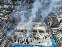 An aerial view shows smoke rises after a massive fire broke out, at the Mohammadpur Krishi Market in Dhaka, Bangladesh, on September 14, 202...