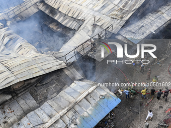 Firefighters and local people try to extinguish a fire that broke out, at the Mohammadpur Krishi Market in Dhaka, Bangladesh, on September 1...