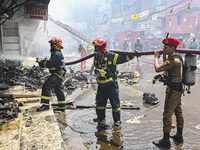 Firefighters try to extinguish a fire that broke out, at the Mohammadpur Krishi Market in Dhaka, Bangladesh, on September 14, 2023.
 (