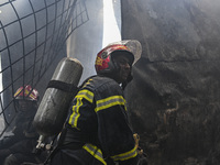 Firefighters try to extinguish a fire that broke out, at the Mohammadpur Krishi Market in Dhaka, Bangladesh, on September 14, 2023.
 (