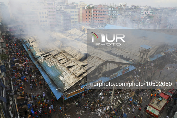 
Firefighters and volunteers are seen at the Mohammadpur Krishi Market, while smoke rises after a massive fire broke out, in Dhaka, Banglad...