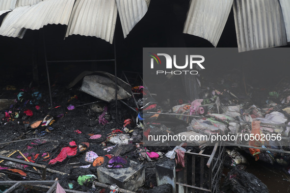 
Firefighters and volunteers are seen at the Mohammadpur Krishi Market, while smoke rises after a massive fire broke out, in Dhaka, Banglad...