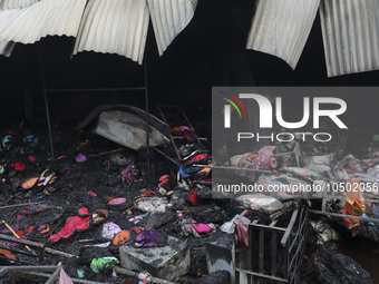 
Firefighters and volunteers are seen at the Mohammadpur Krishi Market, while smoke rises after a massive fire broke out, in Dhaka, Banglad...