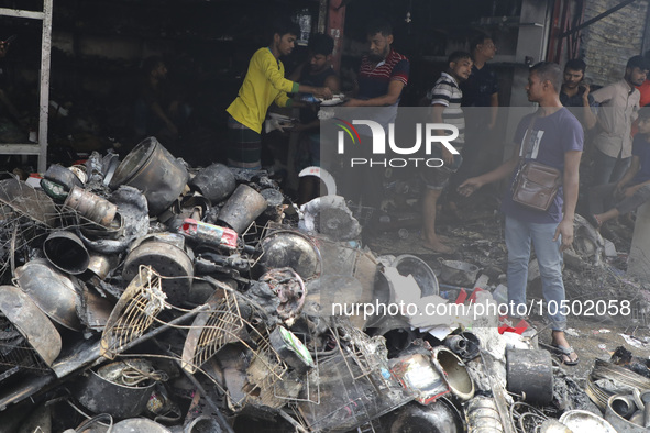 
Firefighters and volunteers are seen at the Mohammadpur Krishi Market, while smoke rises after a massive fire broke out, in Dhaka, Banglad...