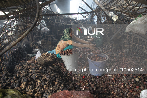 Shopkeepers look for the goods that survived from the massive fire at Mohammadpur Krishi Market in Dhaka on September 14, 2023. A massive bl...