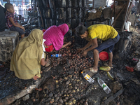 Shopkeepers look for the goods that survived from the massive fire at Mohammadpur Krishi Market in Dhaka on September 14, 2023. A massive bl...