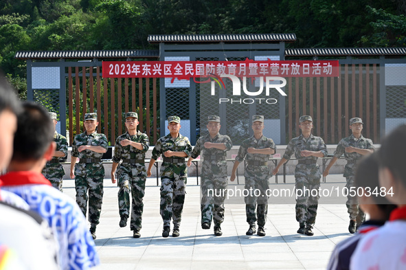 Children watch a Queue Demo at a new recruit training camp in Tianjia town, Neijiang city, Sichuan province, China, Sept. 15, 2023. Septembe...