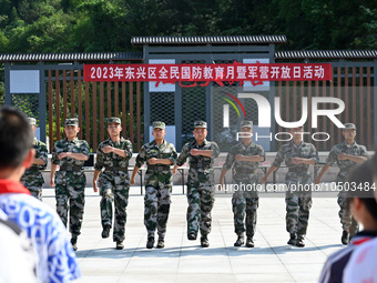 Children watch a Queue Demo at a new recruit training camp in Tianjia town, Neijiang city, Sichuan province, China, Sept. 15, 2023. Septembe...