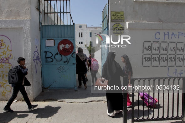 Children enter a school building as the 2023-2024 academic year begins for Tunisian students after the summer holiday in Tunis, Tunisia on S...