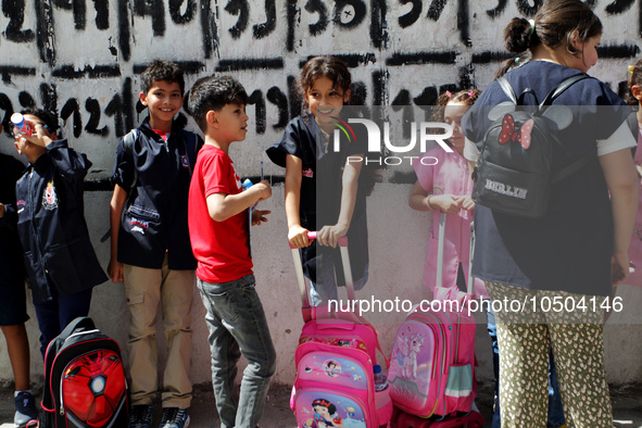 Children  wait in front of a school as the 2023-2024 academic year begins for Tunisian students after the summer holiday in Tunis, Tunisia o...