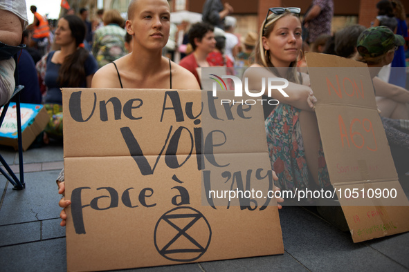 A young woman holds a placard reading 'Another way is possible against the A69'.Extinction Rebellion (XR) Toulouse organized a sit-in of wom...