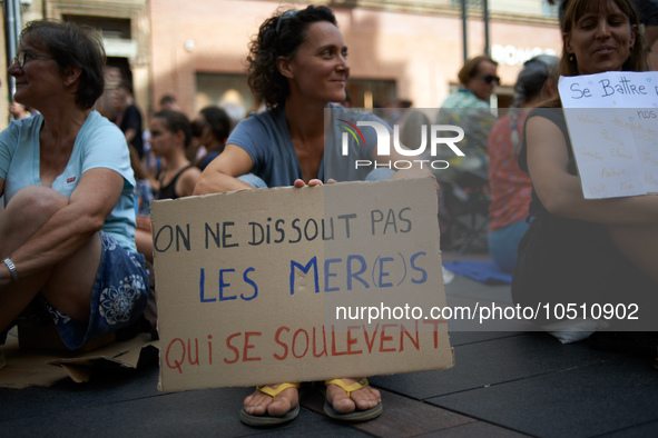 A woman holds a placard reading 'One can't dissolve Mothers who rise up'. Extinction Rebellion (XR) Toulouse organized a sit-in of women in...