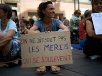 A woman holds a placard reading 'One can't dissolve Mothers who rise up'. Extinction Rebellion (XR) Toulouse organized a sit-in of women in...