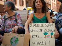A woman holds a placard reading 'Later, I would be...alive'.  Extinction Rebellion (XR) Toulouse organized a sit-in of women in one of the m...