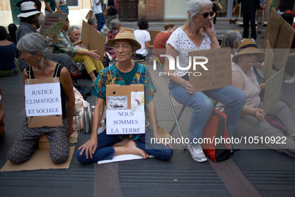 Womaen hold placards reading 'Social and climatic justice', 'we're Earth'. Extinction Rebellion (XR) Toulouse organized a sit-in of women in...