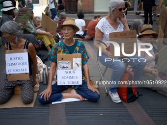 Womaen hold placards reading 'Social and climatic justice', 'we're Earth'. Extinction Rebellion (XR) Toulouse organized a sit-in of women in...