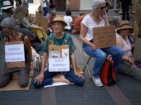 Womaen hold placards reading 'Social and climatic justice', 'we're Earth'. Extinction Rebellion (XR) Toulouse organized a sit-in of women in...