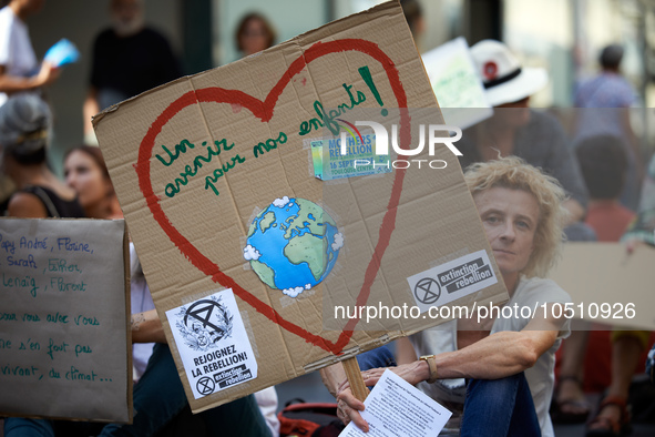 A woman holds a cardboard'Afuture for our children'. Extinction Rebellion (XR) Toulouse organized a sit-in of women in one of the most frequ...