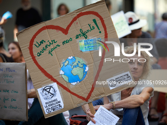 A woman holds a cardboard'Afuture for our children'. Extinction Rebellion (XR) Toulouse organized a sit-in of women in one of the most frequ...