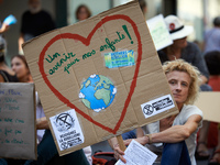 A woman holds a cardboard'Afuture for our children'. Extinction Rebellion (XR) Toulouse organized a sit-in of women in one of the most frequ...