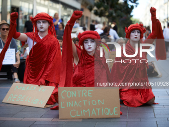 Red Rebels in front of the sit-in. Extinction Rebellion (XR) Toulouse organized a sit-in of women in one of the most frequented street of To...