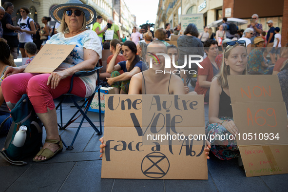 A young woman holds a placard reading 'Another way against the A69'. Extinction Rebellion (XR) Toulouse organized a sit-in of women in one o...