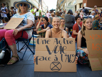 A young woman holds a placard reading 'Another way against the A69'. Extinction Rebellion (XR) Toulouse organized a sit-in of women in one o...