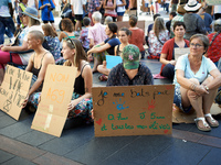 A woman holds a placard reading 'I fight for my O., 7yo, J., 5yo and all my pupils'. Extinction Rebellion (XR) Toulouse organized a sit-in o...