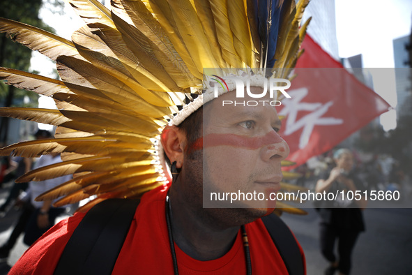 An indigenous person marches among thousands representing various groups participate in the ''End of Fossil Fuels'' protest across Midtown M...