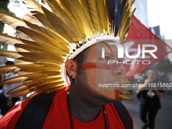 An indigenous person marches among thousands representing various groups participate in the ''End of Fossil Fuels'' protest across Midtown M...