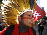 An indigenous person marches among thousands representing various groups participate in the ''End of Fossil Fuels'' protest across Midtown M...