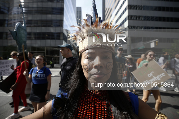 An indigenous person marches among thousands representing various groups participate in the ''End of Fossil Fuels'' protest across Midtown M...