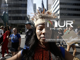 An indigenous person marches among thousands representing various groups participate in the ''End of Fossil Fuels'' protest across Midtown M...