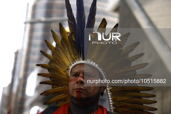 An indigenous person marches among thousands representing various groups participate in the ''End of Fossil Fuels'' protest across Midtown M...