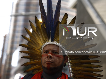 An indigenous person marches among thousands representing various groups participate in the ''End of Fossil Fuels'' protest across Midtown M...