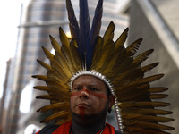 An indigenous person marches among thousands representing various groups participate in the ''End of Fossil Fuels'' protest across Midtown M...