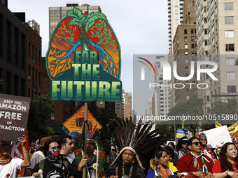 Indigenous people march among thousands representing various groups that participate in the ''End of Fossil Fuels'' protest across Midtown M...