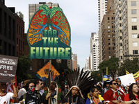 Indigenous people march among thousands representing various groups that participate in the ''End of Fossil Fuels'' protest across Midtown M...