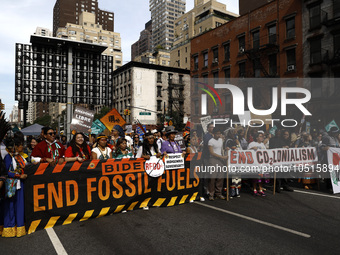 Indigenous people march among thousands representing various groups that participate in the ''End of Fossil Fuels'' protest across Midtown M...