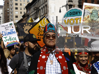 Indigenous people march among thousands representing various groups that participate in the ''End of Fossil Fuels'' protest across Midtown M...