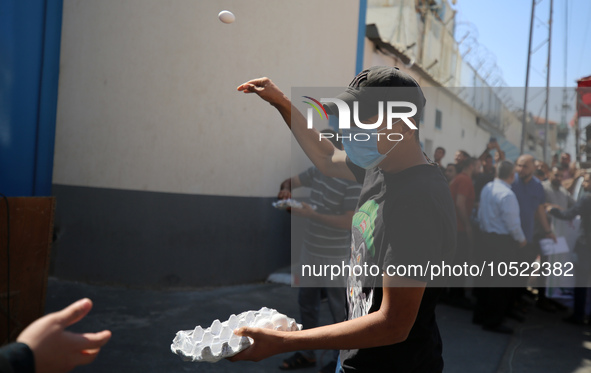 Palestinian protesters throw eggs at the entrance of the Gaza City headquarters of the United Nations Relief and Works Agency for Palestine...