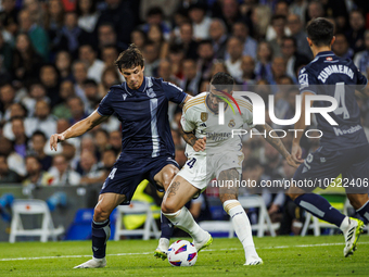 
Robin Le Normand of Real Sociedad in action with Joselu of Real Madrid during the LaLiga EA Sports match between Real Madrid  and Real Soci...