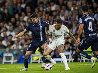 
Robin Le Normand of Real Sociedad in action with Joselu of Real Madrid during the LaLiga EA Sports match between Real Madrid  and Real Soci...