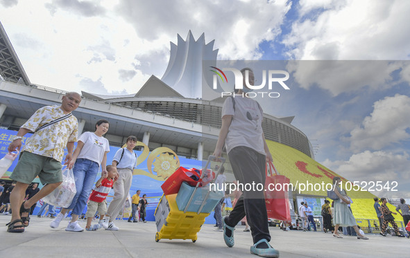 NANNING, CHINA - SEPTEMBER 19, 2023 - People walk out of the venue of the ASEAN Expo with purchased goods in Nanning, Guangxi province, Chin...