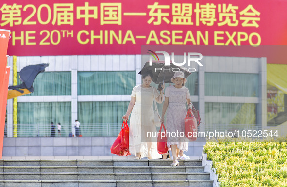 NANNING, CHINA - SEPTEMBER 19, 2023 - People walk out of the venue of the ASEAN Expo with purchased goods in Nanning, Guangxi province, Chin...