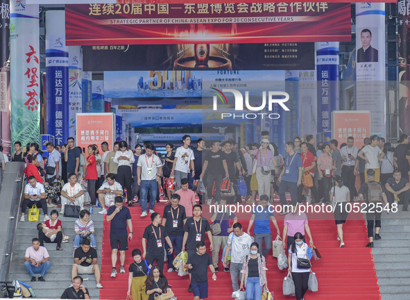 NANNING, CHINA - SEPTEMBER 19, 2023 - People walk out of the venue of the ASEAN Expo with purchased goods in Nanning, Guangxi province, Chin...