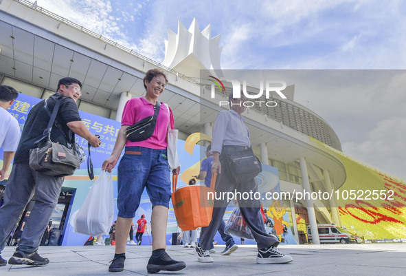 NANNING, CHINA - SEPTEMBER 19, 2023 - People walk out of the venue of the ASEAN Expo with purchased goods in Nanning, Guangxi province, Chin...