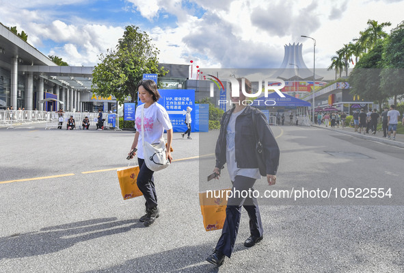 NANNING, CHINA - SEPTEMBER 19, 2023 - People walk out of the venue of the ASEAN Expo with purchased goods in Nanning, Guangxi province, Chin...