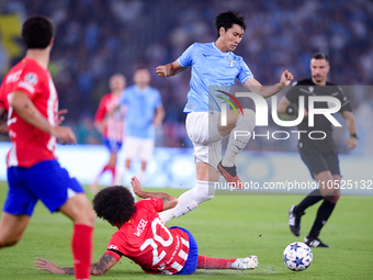 Daichi Kamada of SS Lazio and Axel Witsel of Atletico de Madrid compete for the ball during the UEFA Champions League Group E match between...